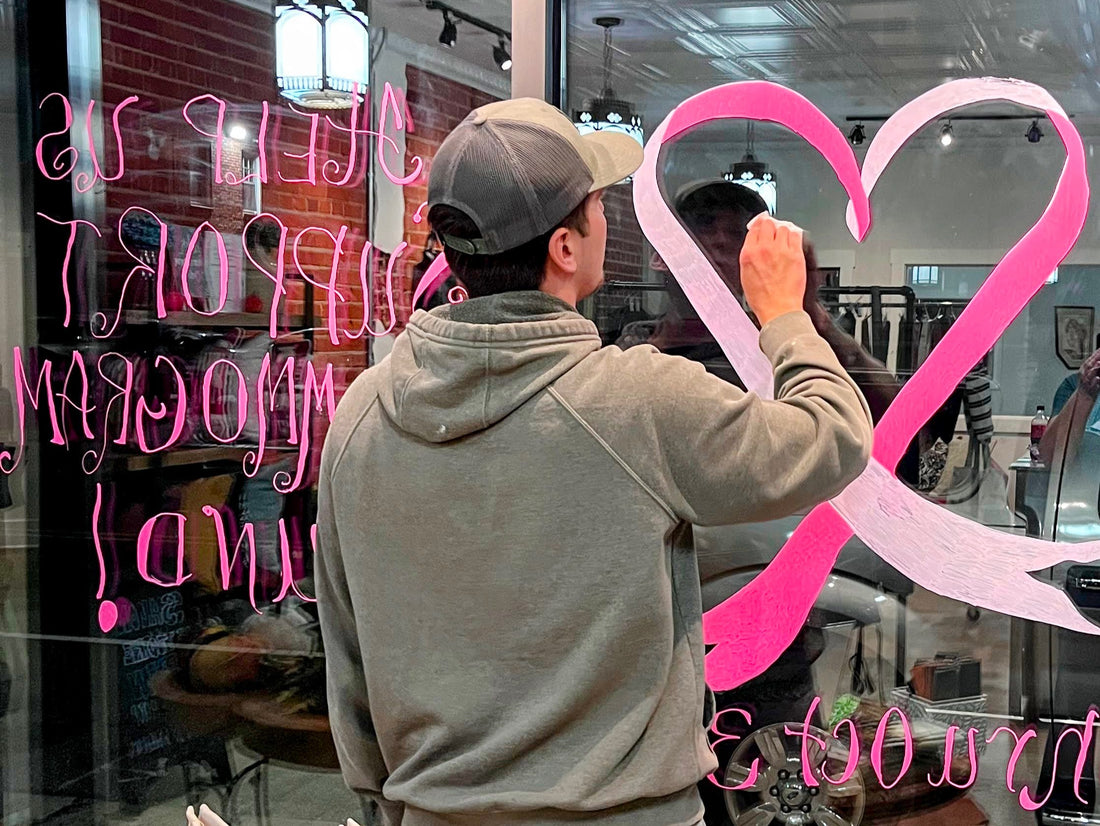 Jeremiah Parker decorates the window of UpStyled Goods for The Pink Project, 2023